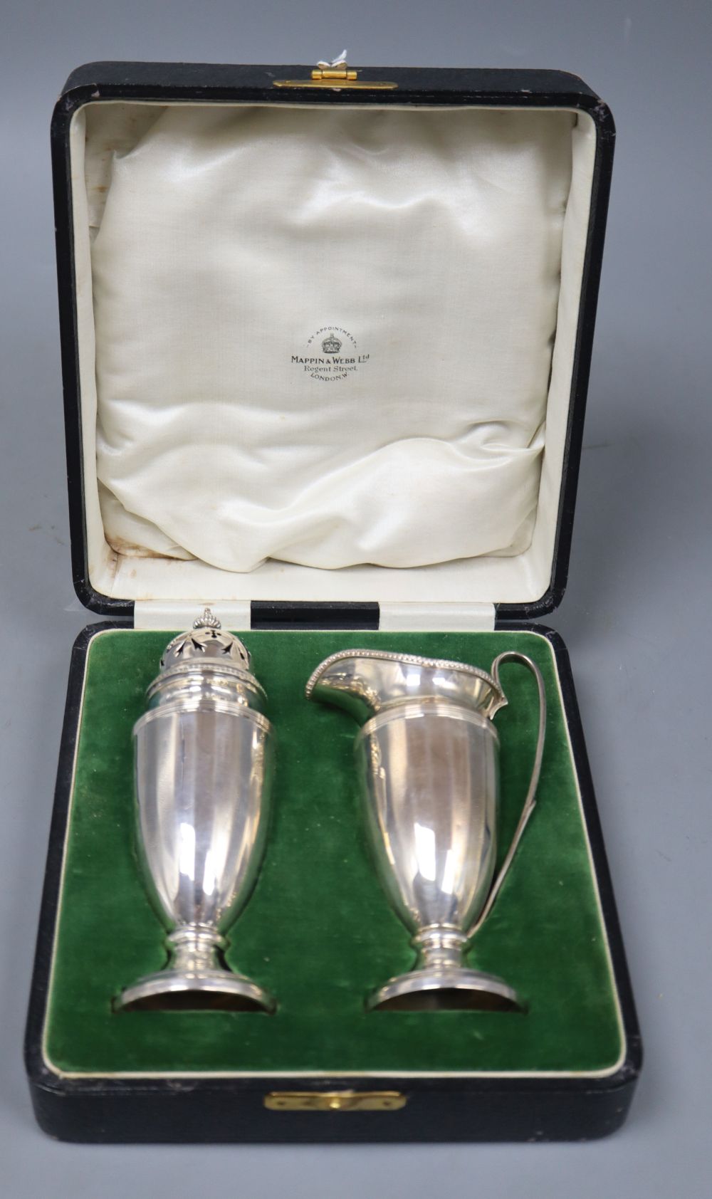 A cased George V silver cream jug and sugar caster by Mappin & Webb, Birmingham, 1925, 6 oz.